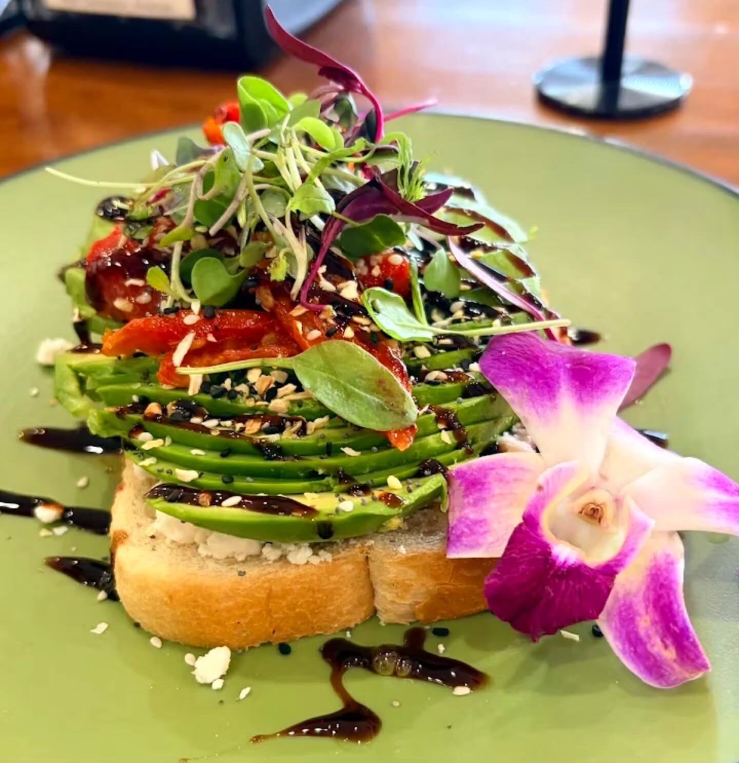 Avocado toast with feta, roasted red pepper and microgreens