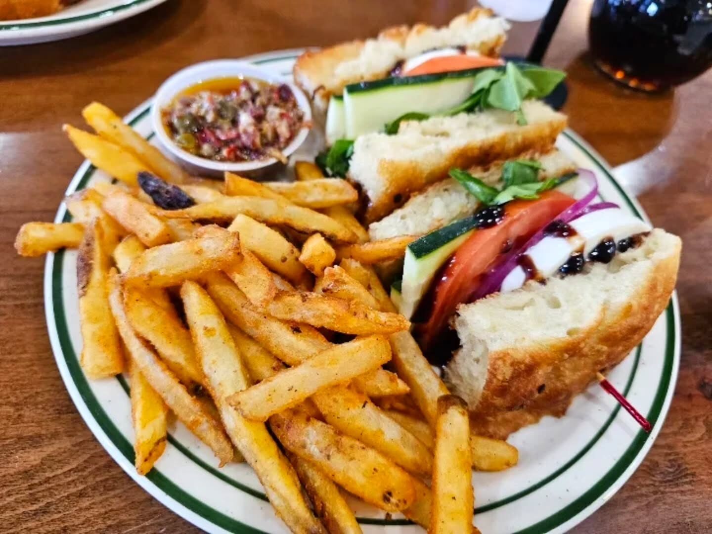 The Sicilian sandwich with mortadella, arugula and stracciatella cheese, served with seasoned fries